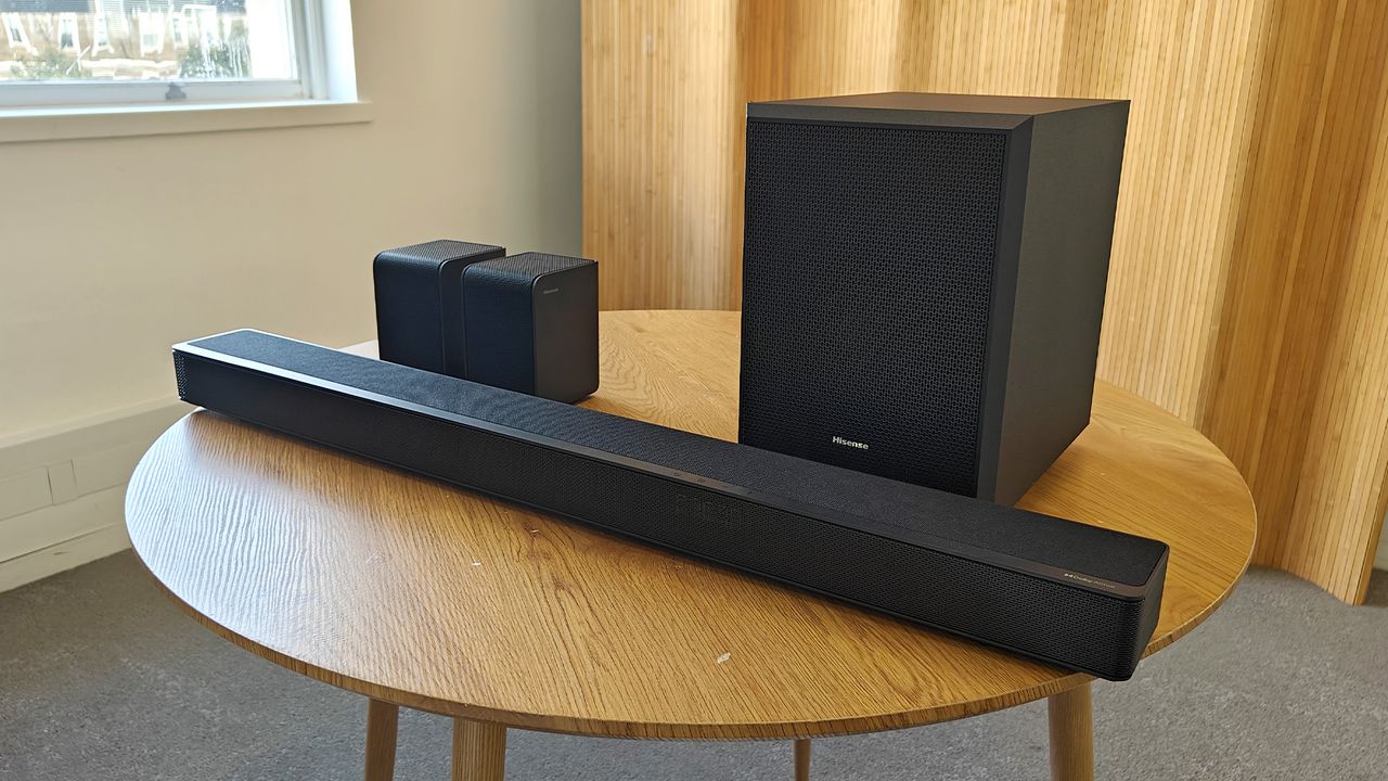 The Hisense AX5125H Dolby Atmos soundbar system, pictured on a round, wooden table