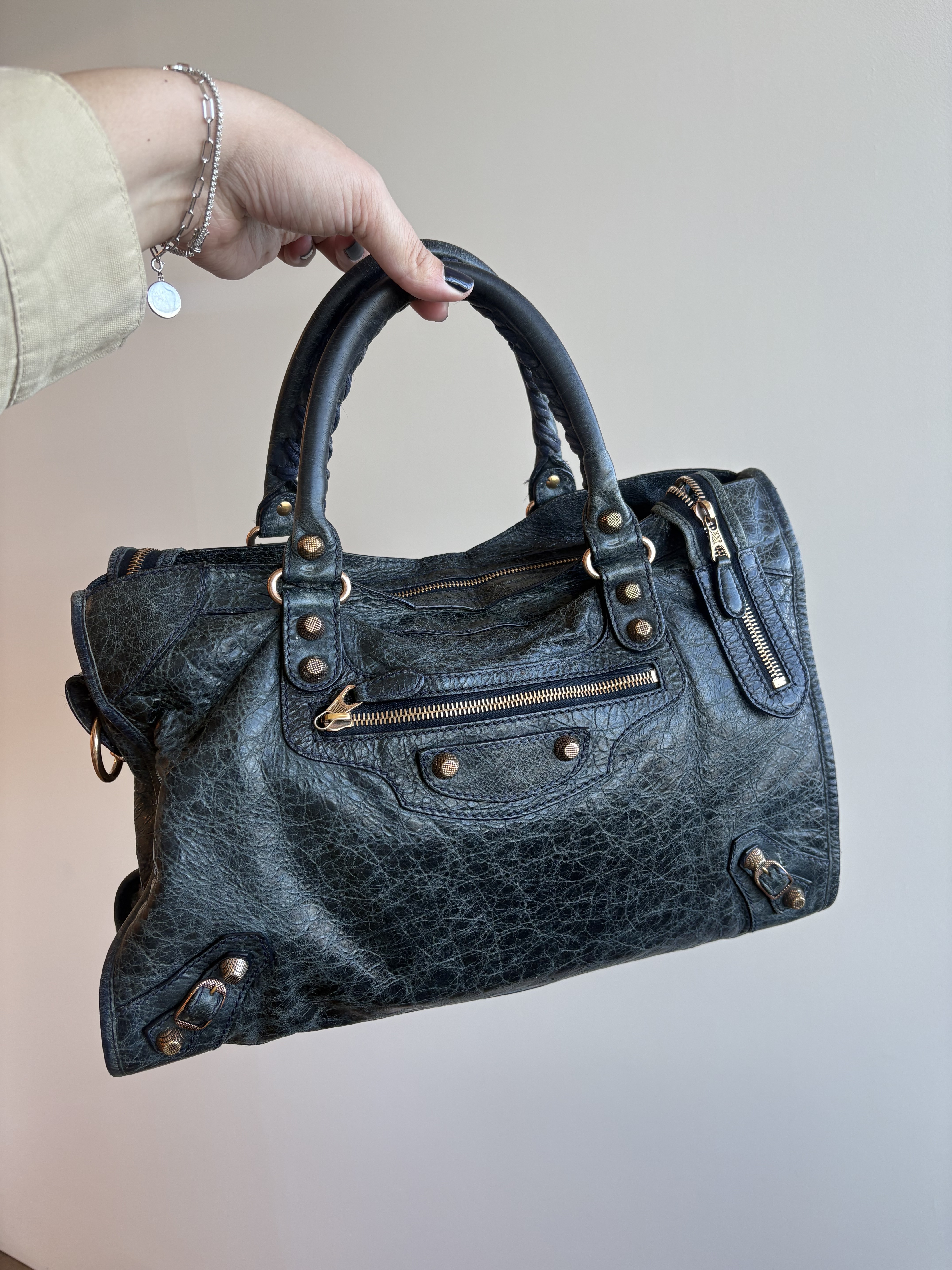 Who What Wear editor Ana Escalante holding up the Balenciaga City bag.