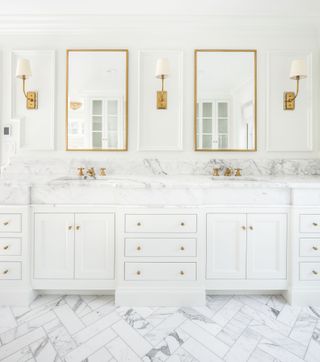 white bathroom with marble herringbone tiled flooring