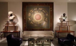 Seating area with sofas, chairs and a large piece of art work on the wall