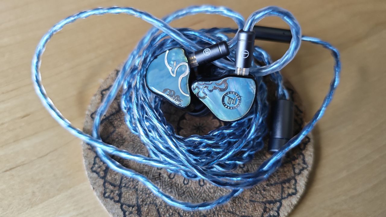 Three photos of the Juzear Defiant IEM.