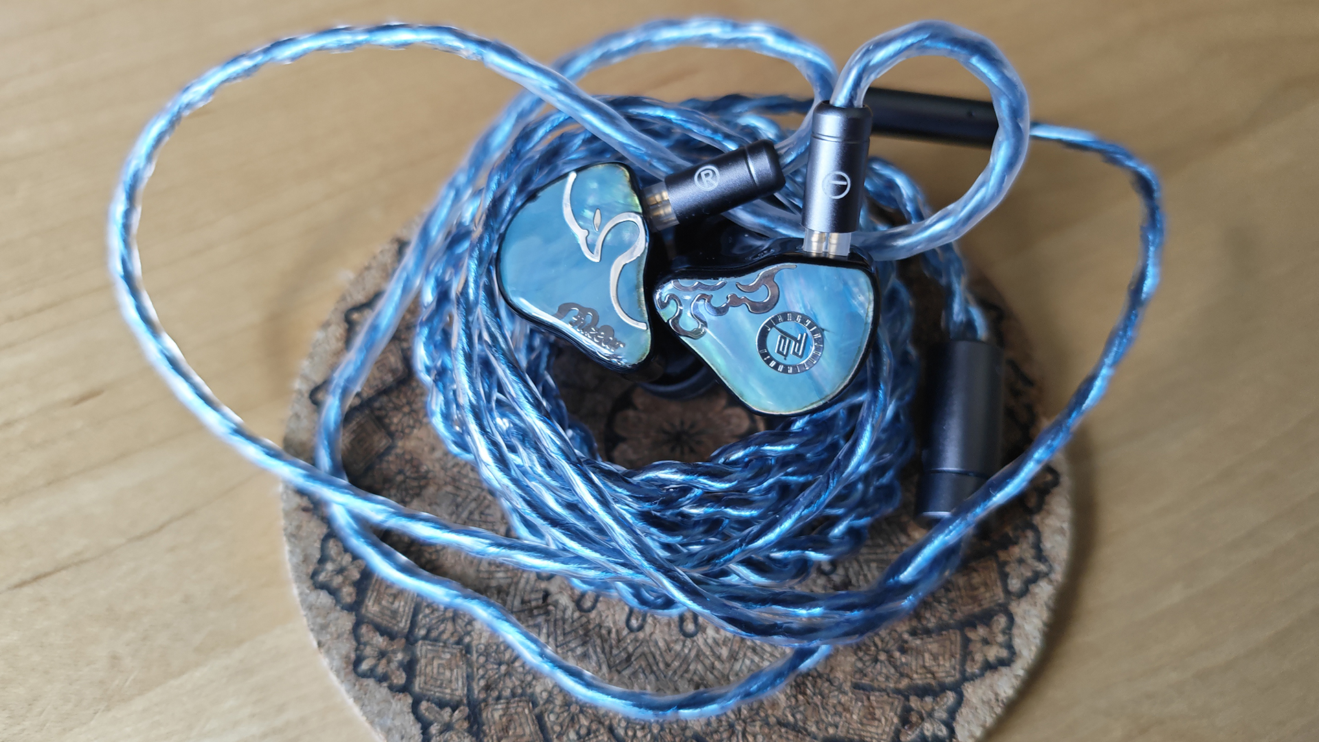 Three photos of the Juzear Defiant IEM. 