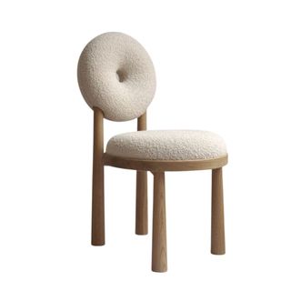 A chair with a round back in beige color fabric