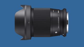 The Sigma 16mm f/1.4 DC DN Contemporary against a blue background