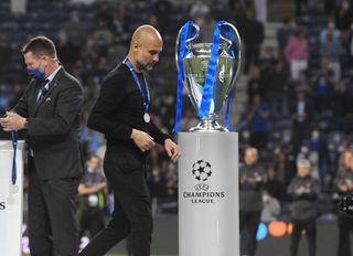 Pep Guardiola, Manager of Manchester City looks dejected as he walks past the Champions League Trophy after the UEFA Champions League Final between Manchester City and Chelsea FC at Estadio do Dragao on May 29, 2021 in Porto, Portugal.