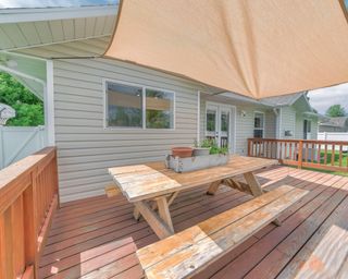 Outdoor patio on a deck of a house with shade sail