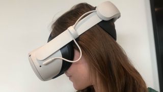A woman wearing the Oculus Quest 2 with Elite Strap and Battery