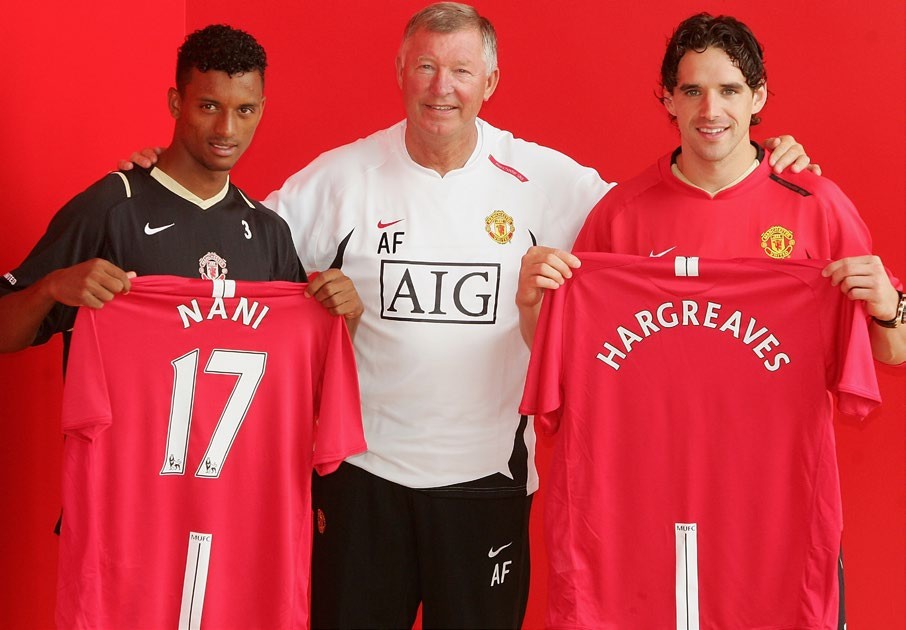 Owen Hargreaves and Nani hold Manchester United jerseys alongside manager Sir Alex Ferguson during their unveiling at the club.