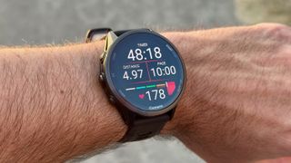 The Garmin Forerunner 970 showing the main Running widget, with time, distance, pace, and heart rate.