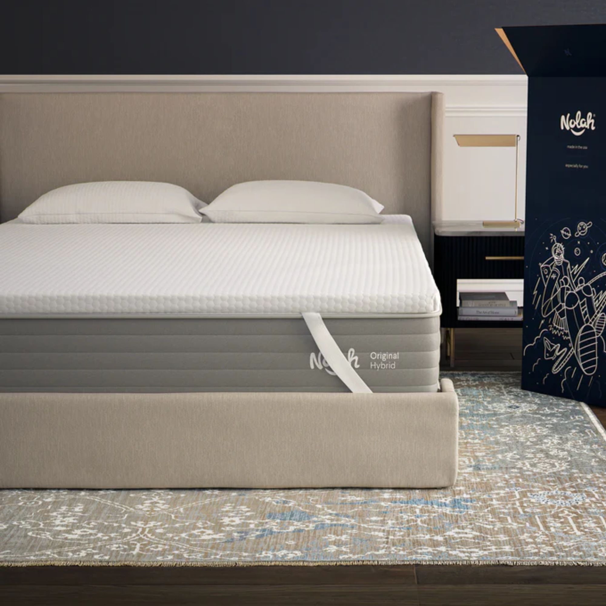 A white Nolah AirFoam&amp;reg; Luxe Mattress Topper on a beige bed with beige headboard, on a Persian-style rug.