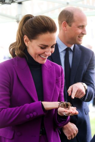 Prince George's parents Prince William, Duke of Cambridge observes as Catherine, Duchess of Cambridge handles a tarantula called Charlotte from Kidz Farm during a tour of the Ulster University Magee Campus on September 29, 2021 in Derry/Londonderry, Northern Ireland.