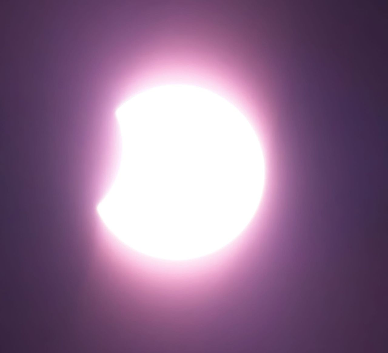 close up view of the sun as the moon starts to cover it.
