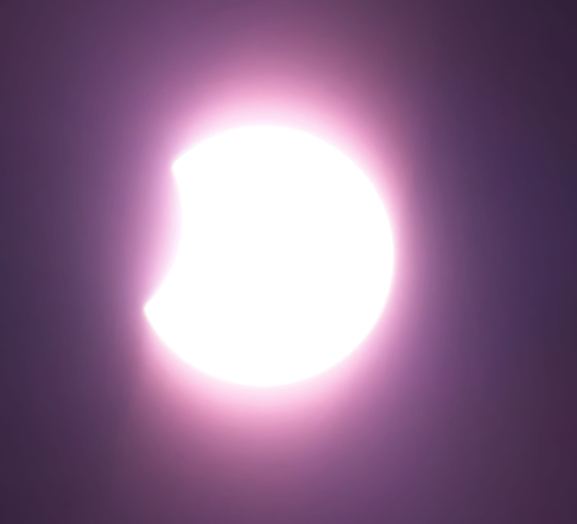 close up view of the sun as the moon starts to cover it.