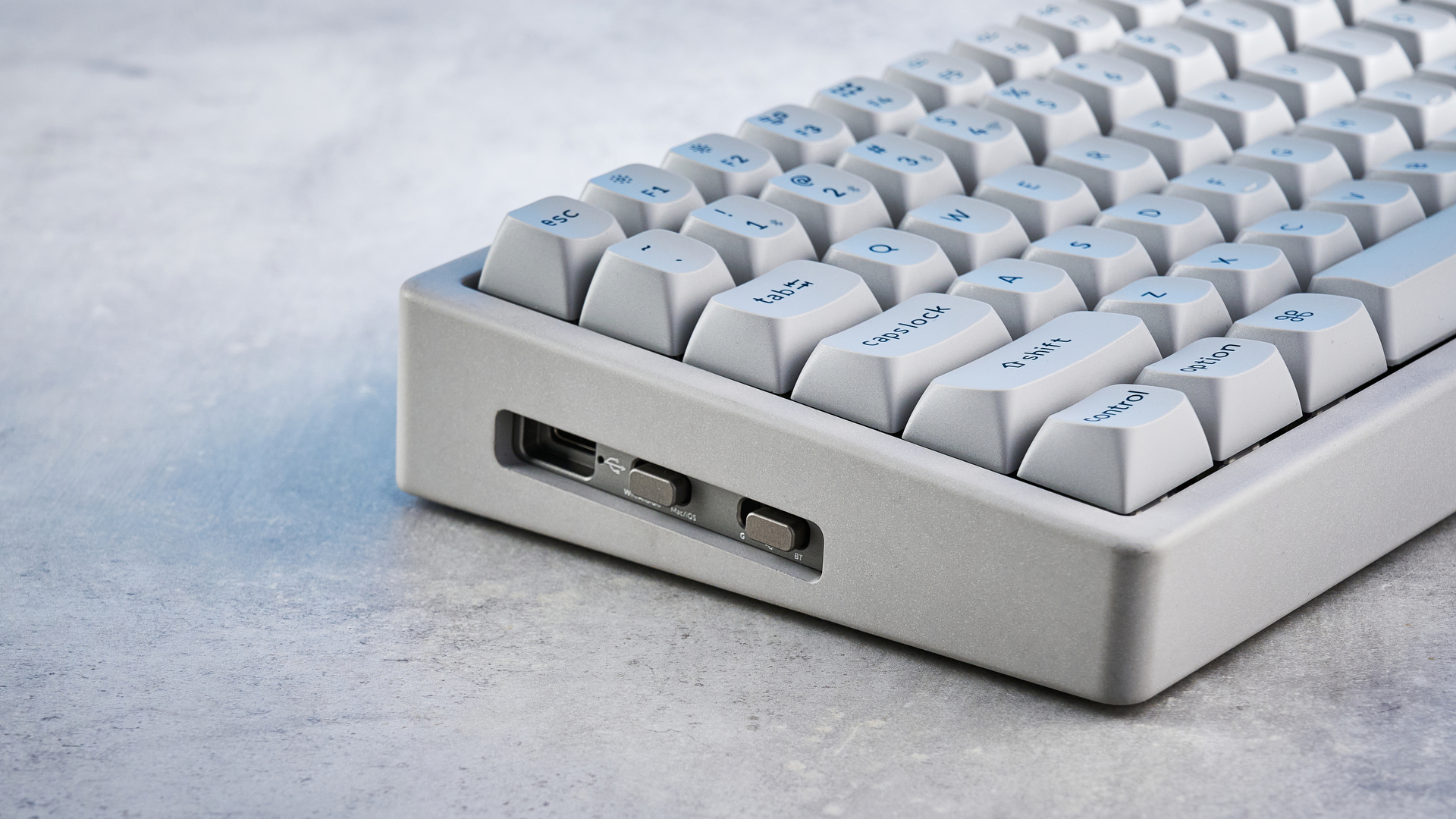 The Keychron K2 HE in concrete, on a stone surface.