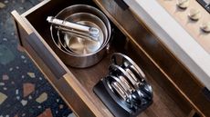 Joseph Joseph pots and pans in timber kitchen drawer next to lids