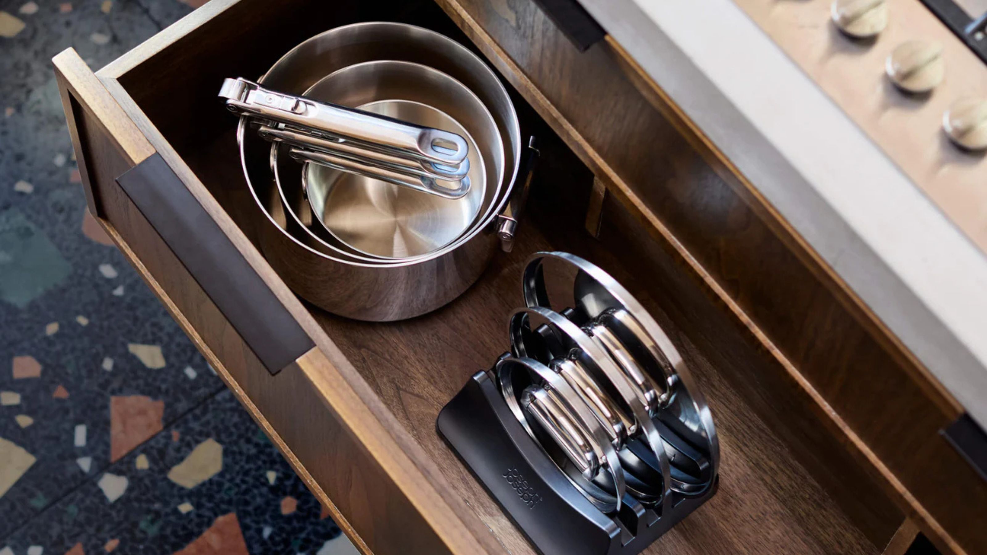 Joseph Joseph pots and pans in timber kitchen drawer next to lids