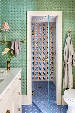 Wet room shower, blue hexagon tile floor, pink wall tiles with blue flower pattern