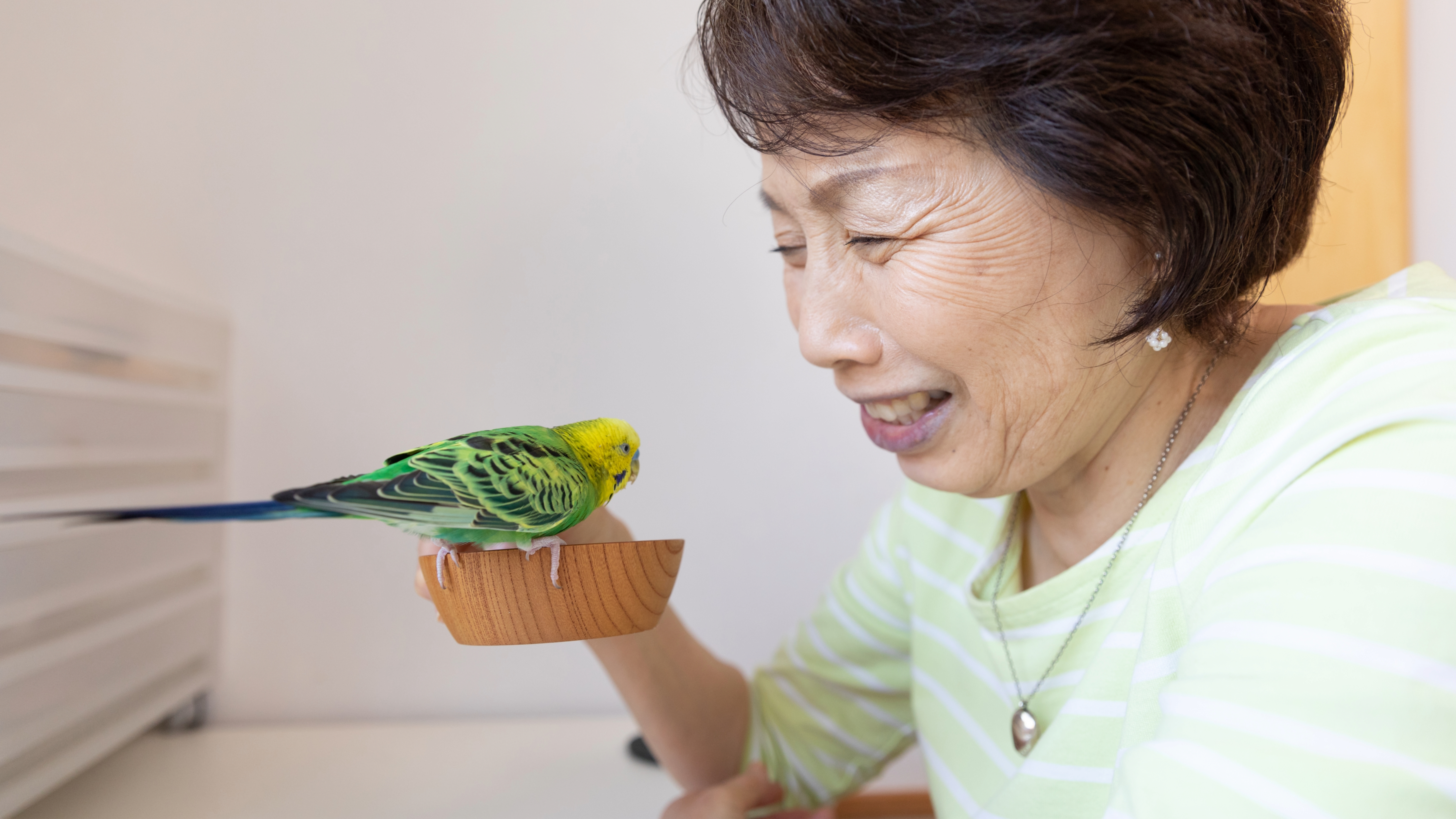 Senior woman and pet bird