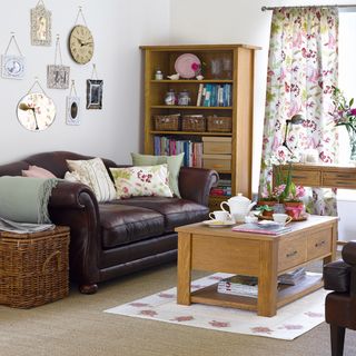 living room with leather sofa and wooden cupboard