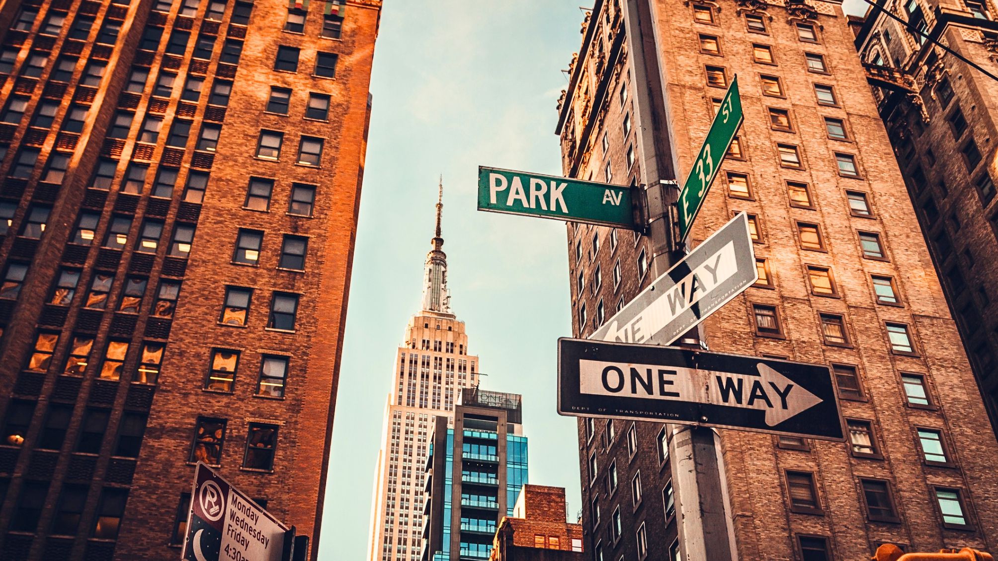 Urban skyline in Midtown Manhattan with distant view of Empire State Building