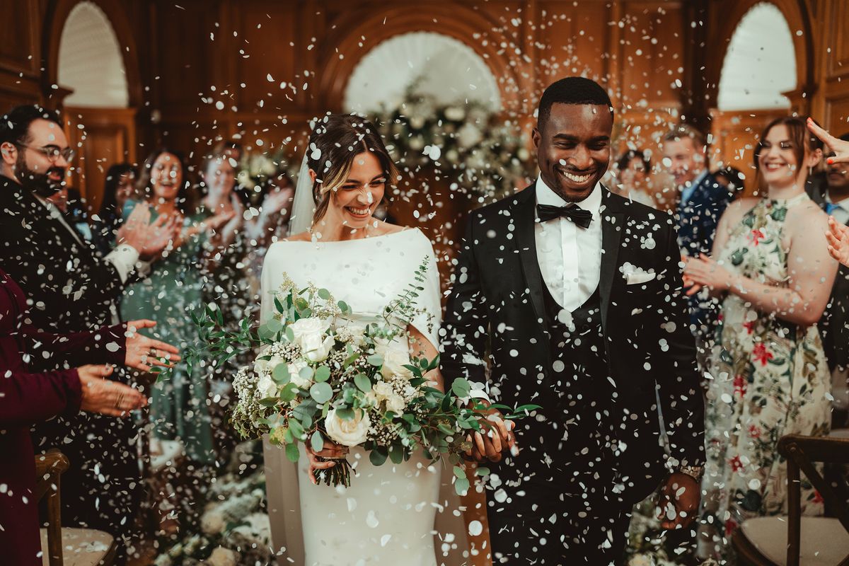 Sample image taken with a Nikon Z 35mm f/1.2 S lens showing a newly married couple showered with confetti