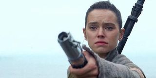 Rey with Luke's lightsaber