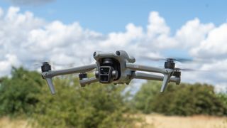 DJI Air 3 flying low over a field