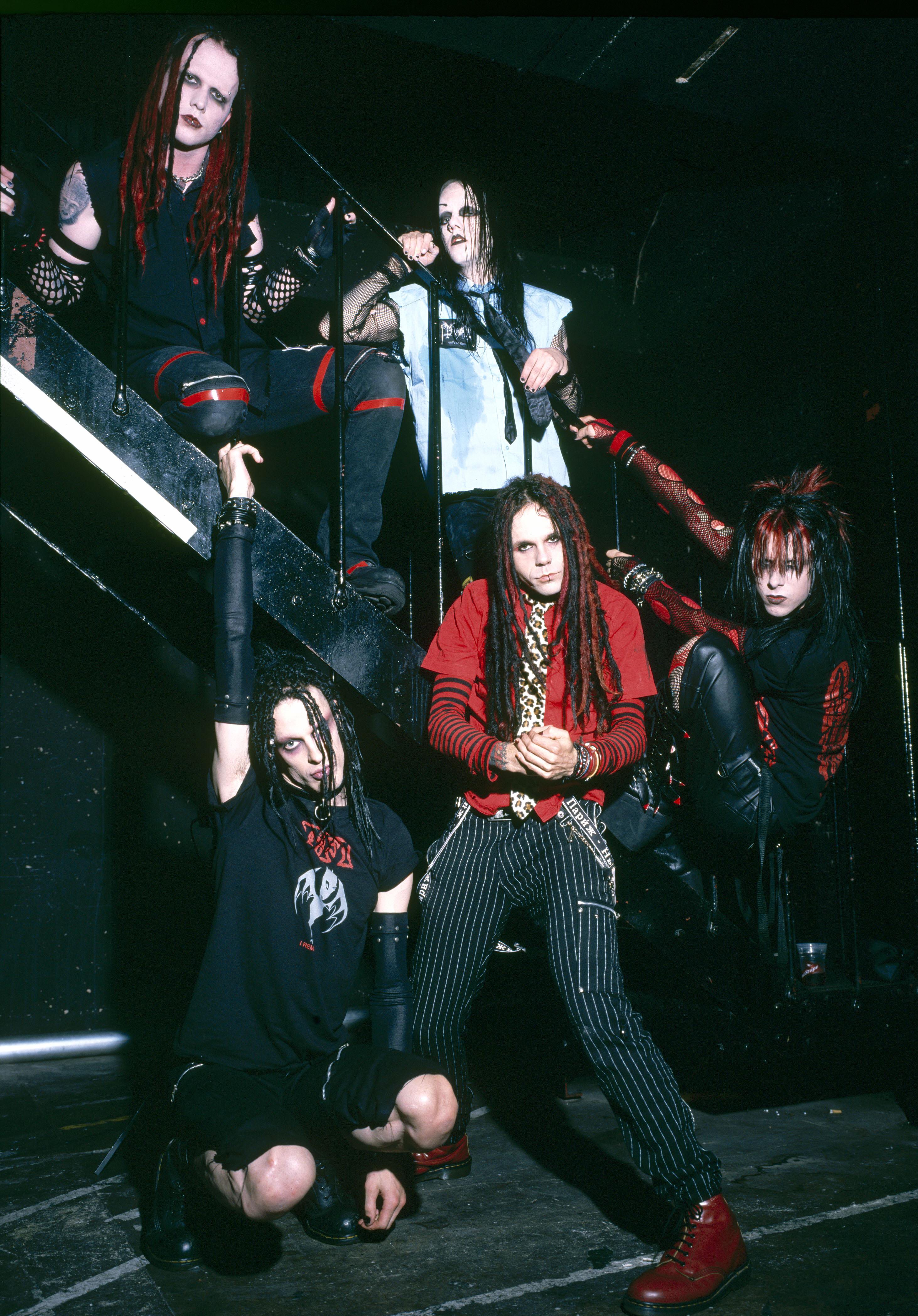 Murderdolls posing by a stairwell