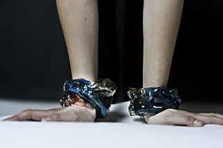 A model wears two bracelets designed by Gaetano Pesce