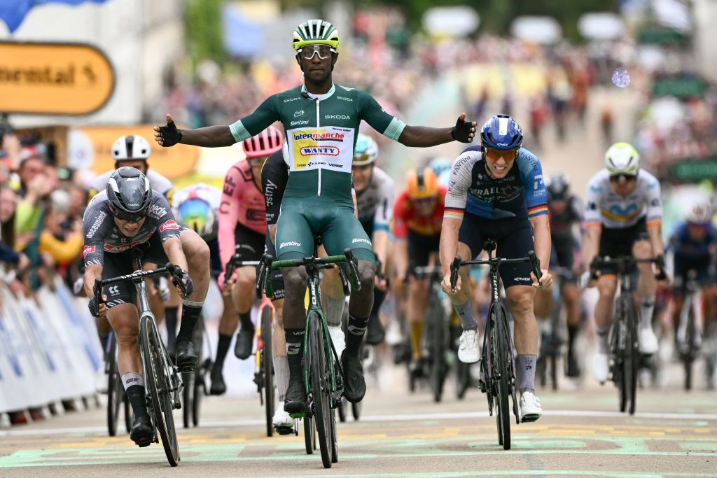 Intermarche - Wanty team's Eritrean rider Biniam Girmay wearing the sprinter's green jersey (C) cycles past the finish line to win the 8th stage of the 111th edition of the Tour de France cycling race, 183,5 km between Semur-en-Auxois and Colombey-les-deux-Eglises, on July 6, 2024. (Photo by Marco BERTORELLO / AFP)