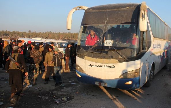 Buses carry evacuees out of eastern Aleppo on Monday.