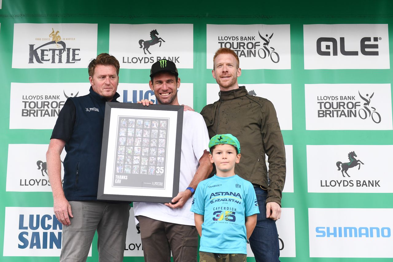 Mark Cavendish on the podium of the Tour of Britain with Rod Ellingworth (L), Ed Clancy (R), and his son, Casper