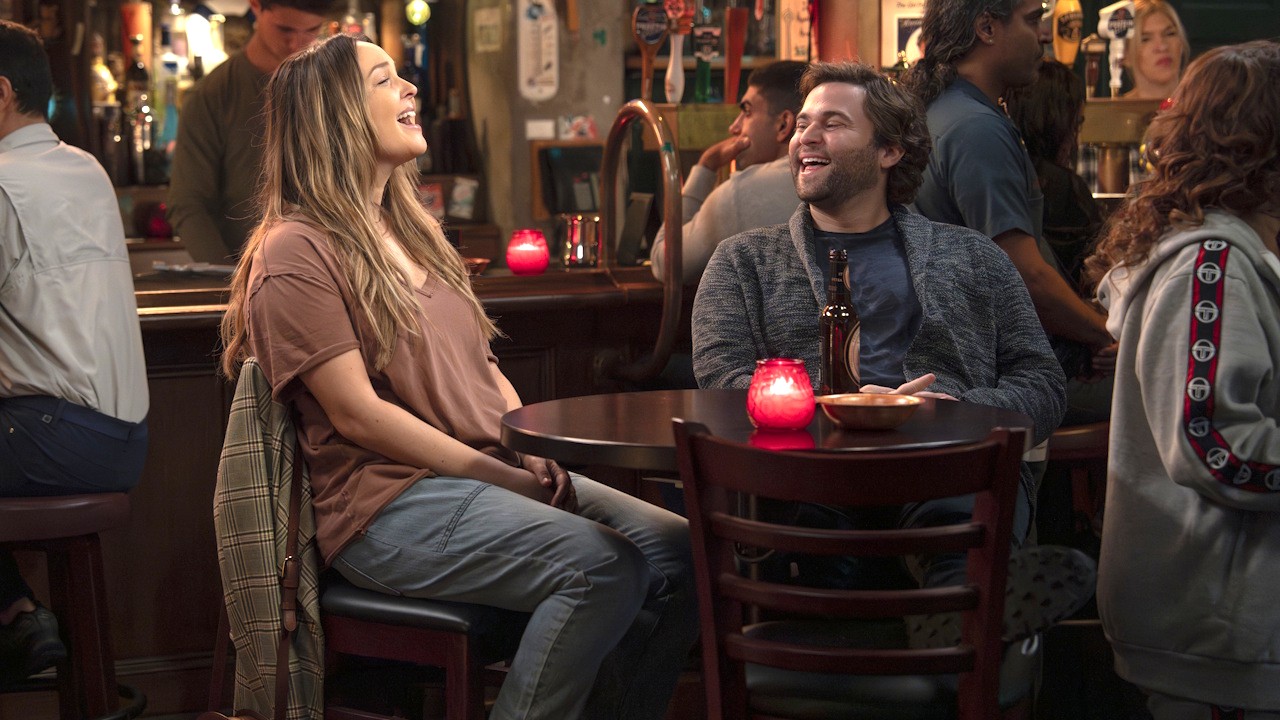 Jo Wilson (Camilla Luddington) and Levi Schmitt (Jake Borelli) laugh during an episode of Grey's Anatomy.