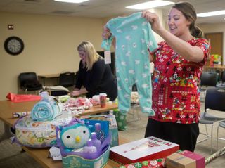 volunteers sorting baby clothes donations
