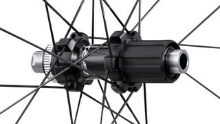 A close up of a black hub with bladed spokes