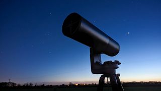 Telescope in-use against starry sky