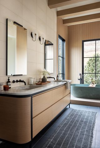 A bathroom with neutral color scheme and freestanding tub