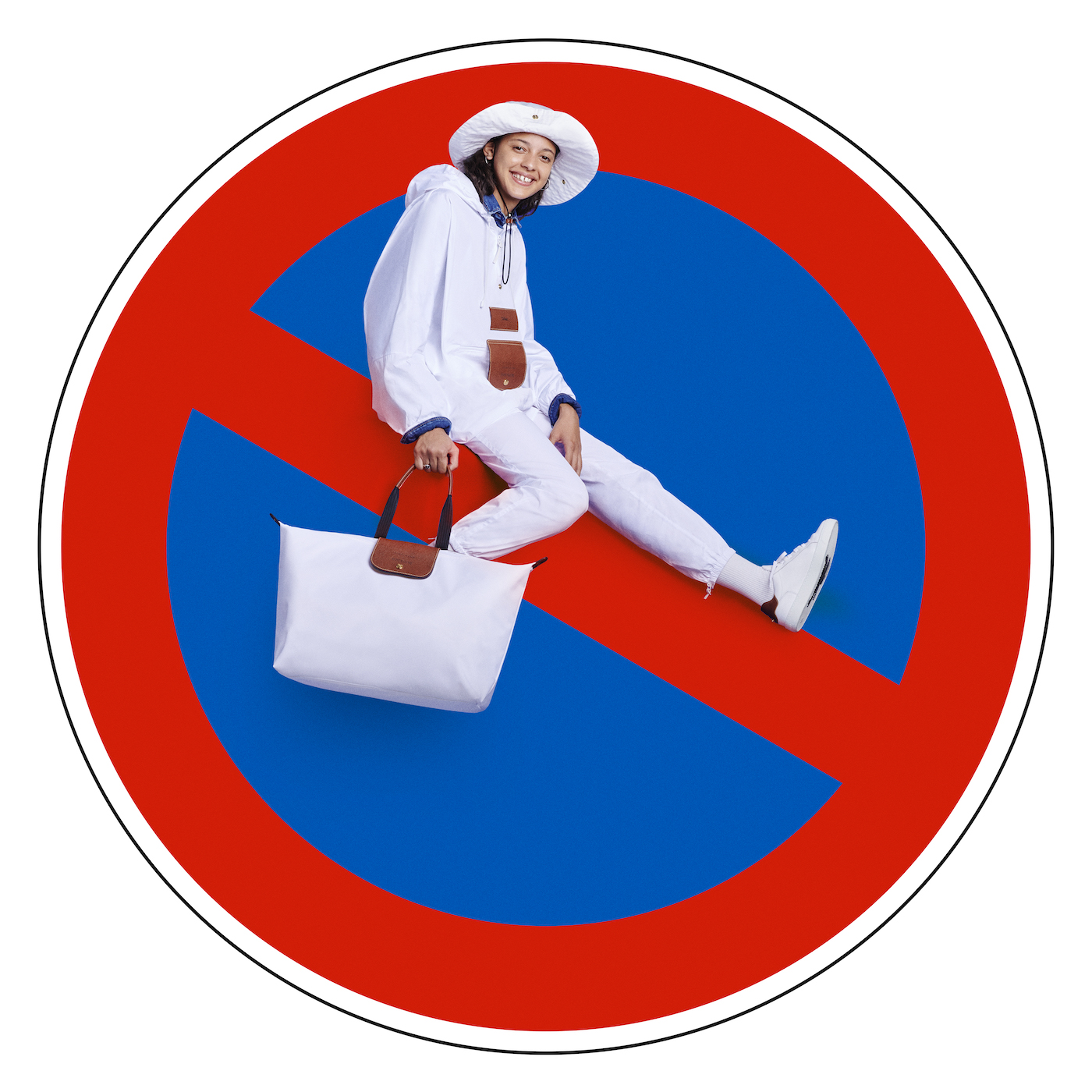 Stop sign with woman in white Longchamp handbag with Le Pliage tote