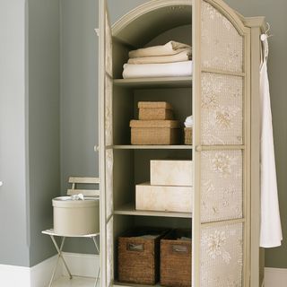 designer cupboard with white wall and basket