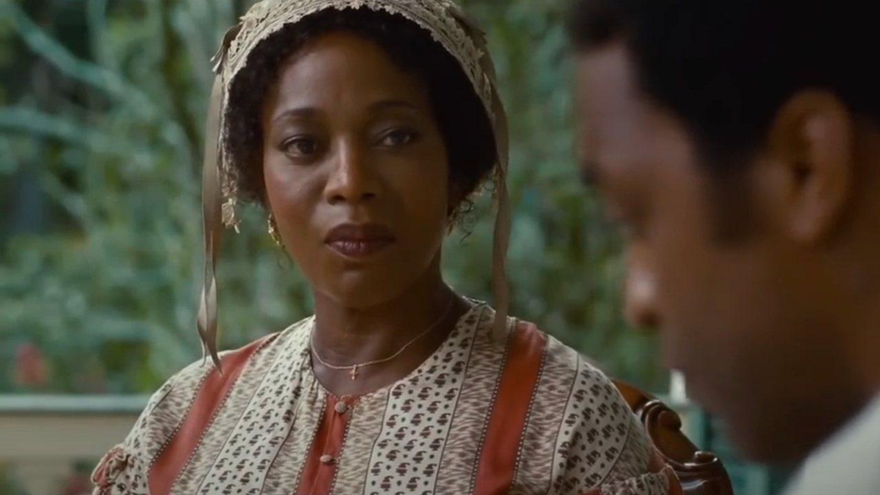 Alfre Woodard sits while looking towards Chiwetel Ejiofor in 12 Years A Slave.