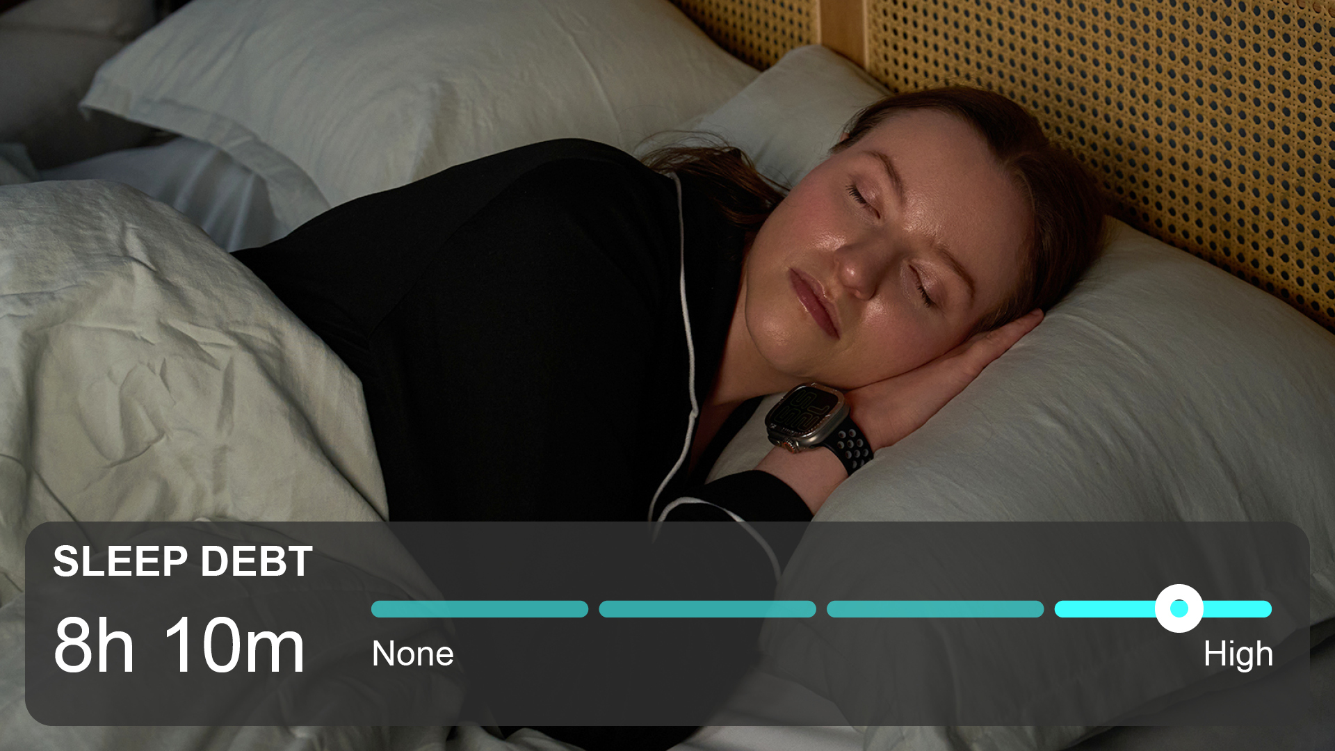 A woman with brown hair sleeps in her bed, while a sleep debt counter is seen below.