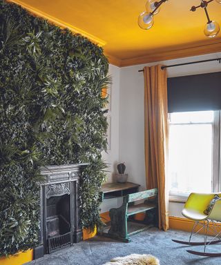 Yellow bedroom idea with painted ceiling and living wall