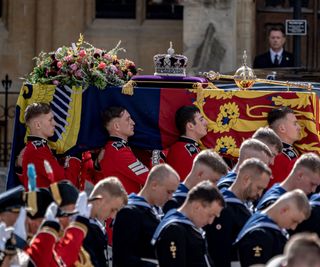 Queen ELizabeth II's coffin with the royal standard flag and bouquet