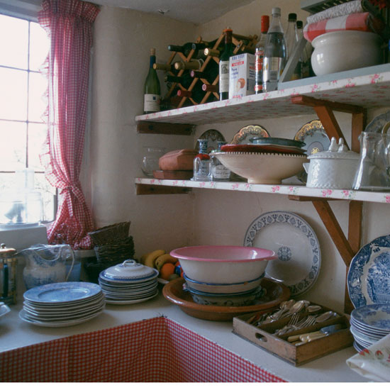 utility room with white counter wall shelf plates and pots