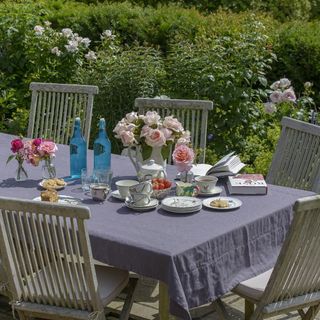 garden with dining table chairs and flowers