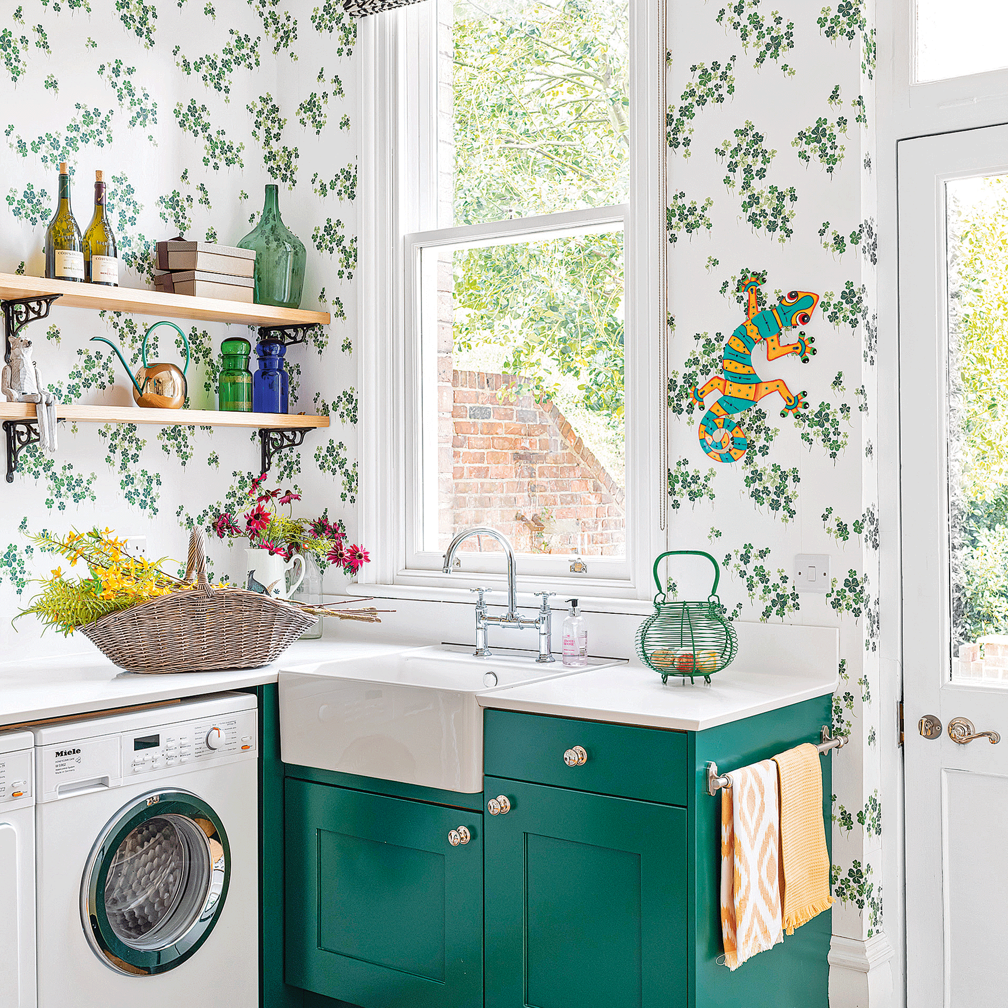 Green and white wallpaper in utility room