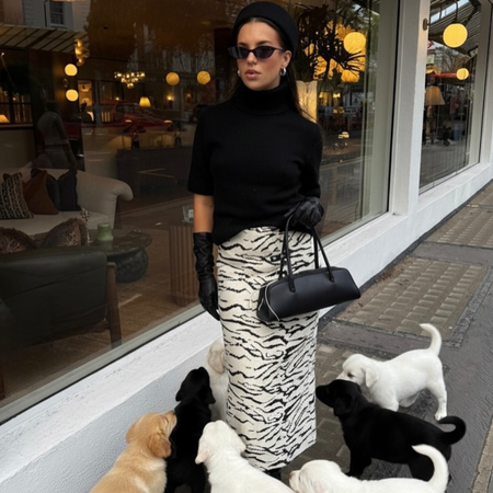 Fashion person Hetty Appletonmiles wears the zebra print skirt trend. She wears a zebra print skirt with a pillbox hat, roll neck jumper and biker boots. This image was recently taken from her Instagram. 