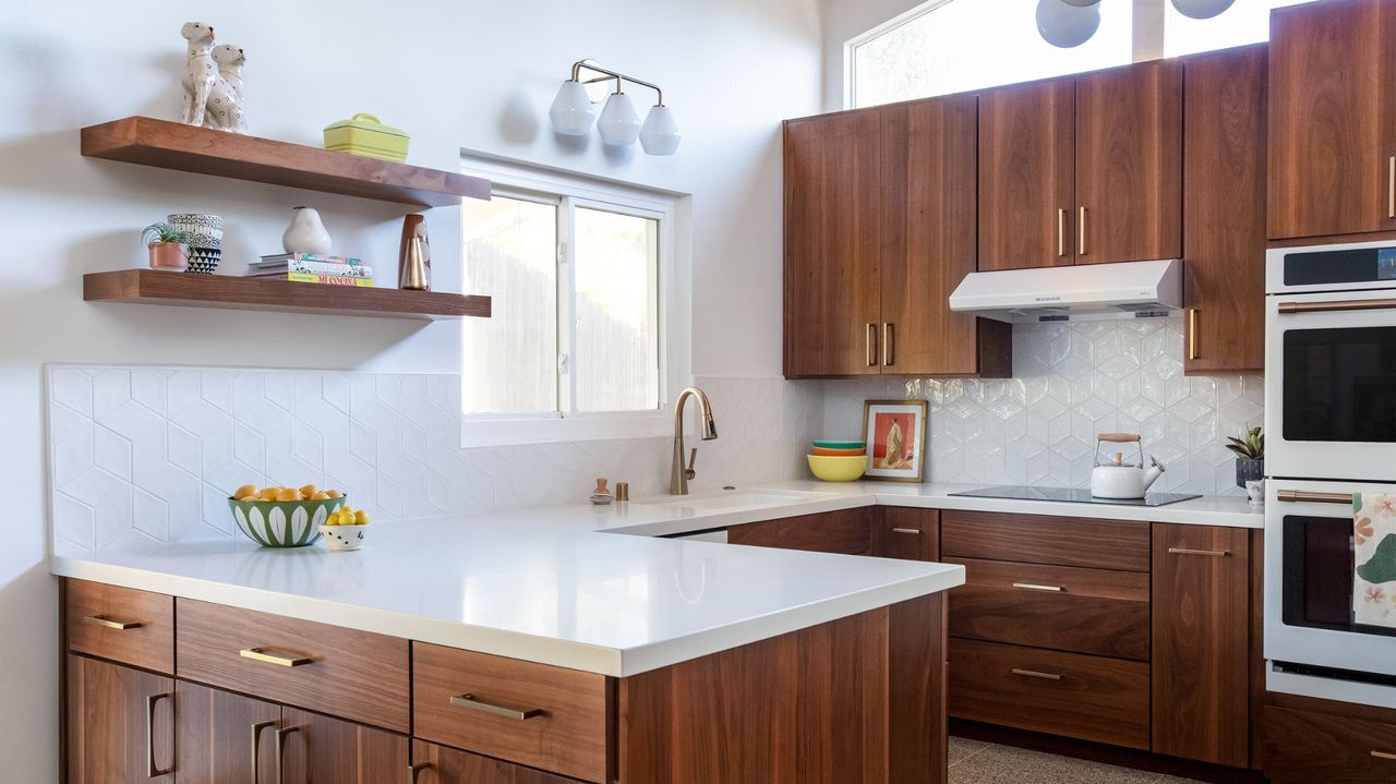 dark wood kitchen with white marble worktops and white walls