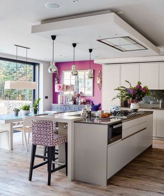kitchen with white and purple wall and wooden flooring