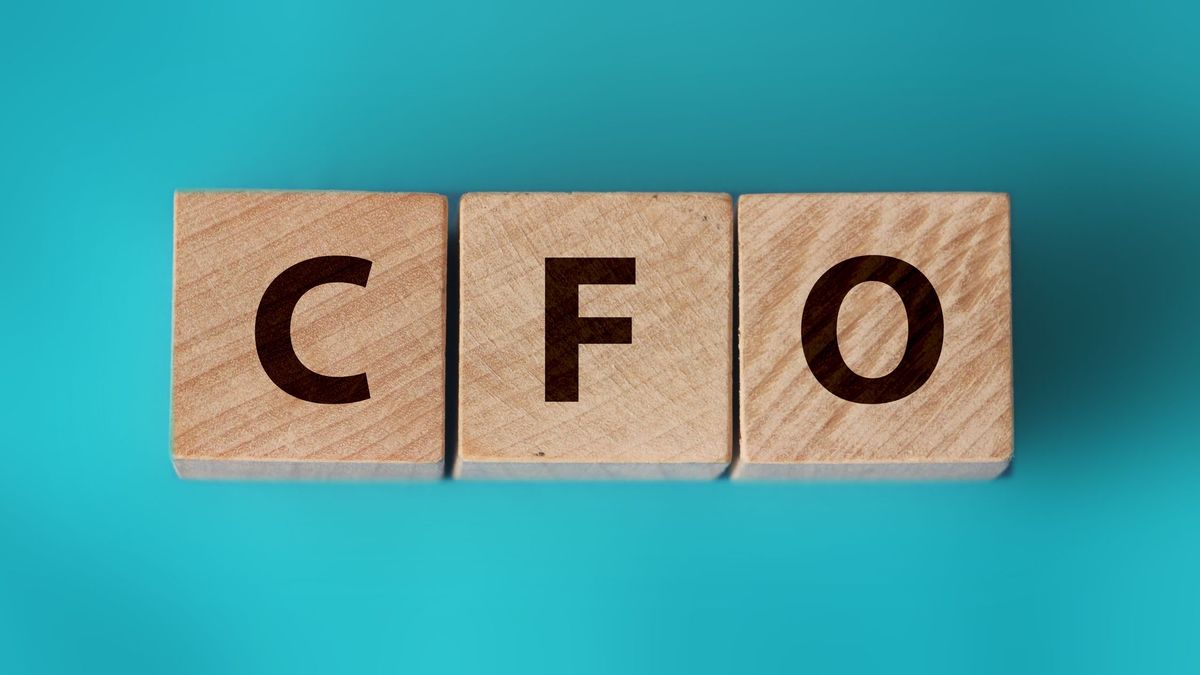 The letters CFO on three wooden blocks on a blue background